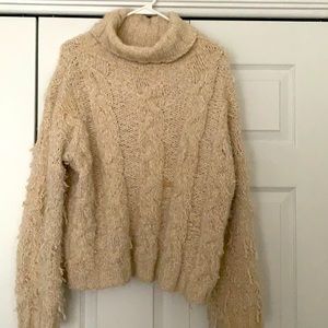 Beige shaggy sweater.